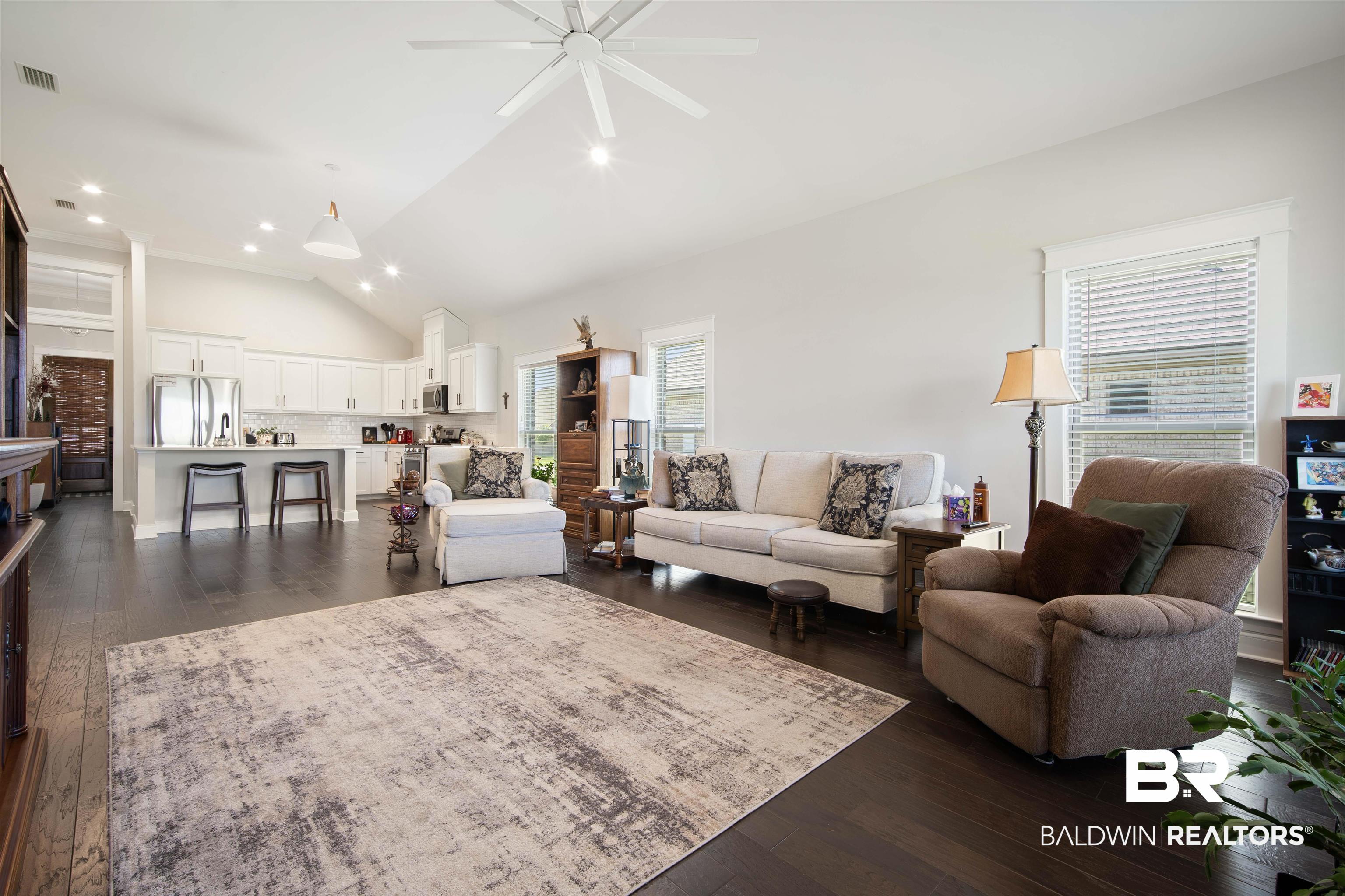 969 Charleston Loop Fairhope, AL 36532 - Photo 5 of 30 Living room featuring ceiling fan, dark hardwood / wood-style floors, and high vaulted ceiling