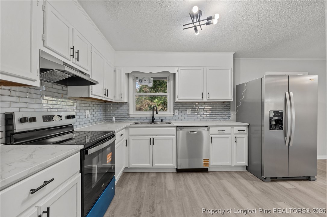 1509 Pope Street Raeford, NC 28376 - Photo 14 of 30 a kitchen with stainless steel appliances granite countertop a stove a sink dishwasher and a refrigerator