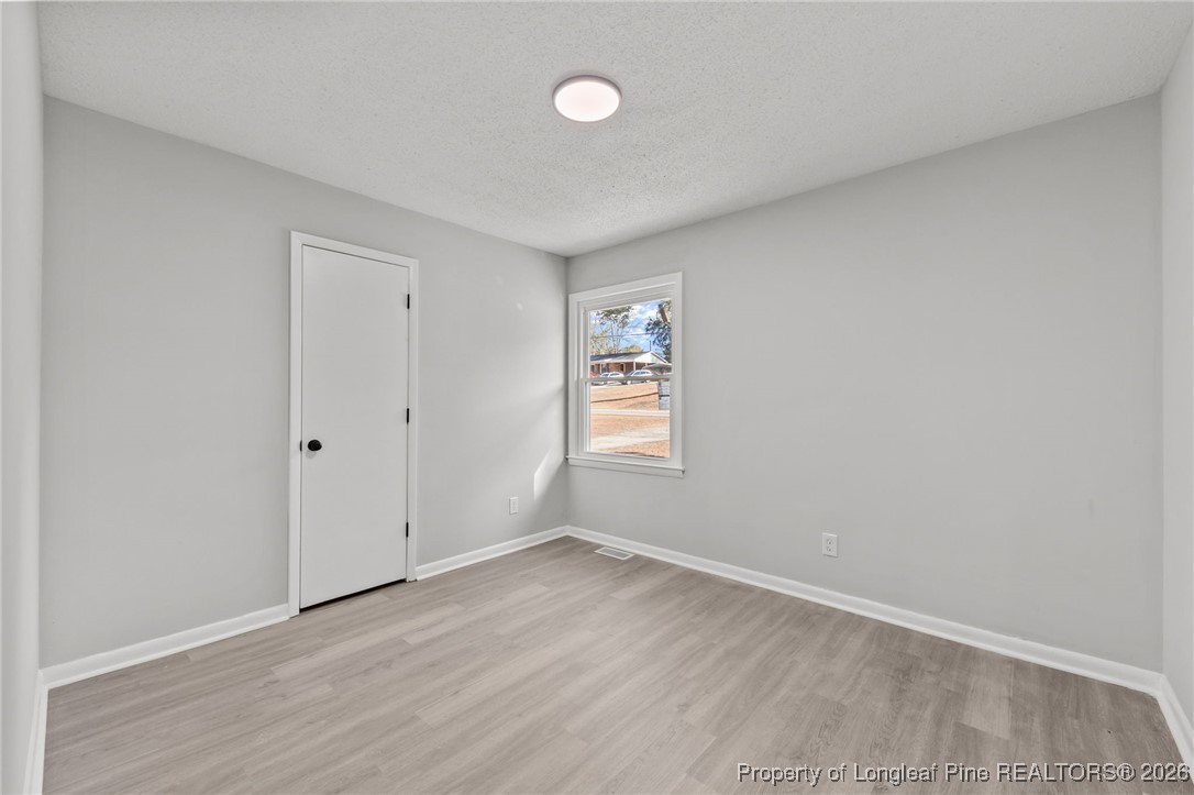 1509 Pope Street Raeford, NC 28376 - Photo 17 of 30 a view of an empty room with wooden floor and a window