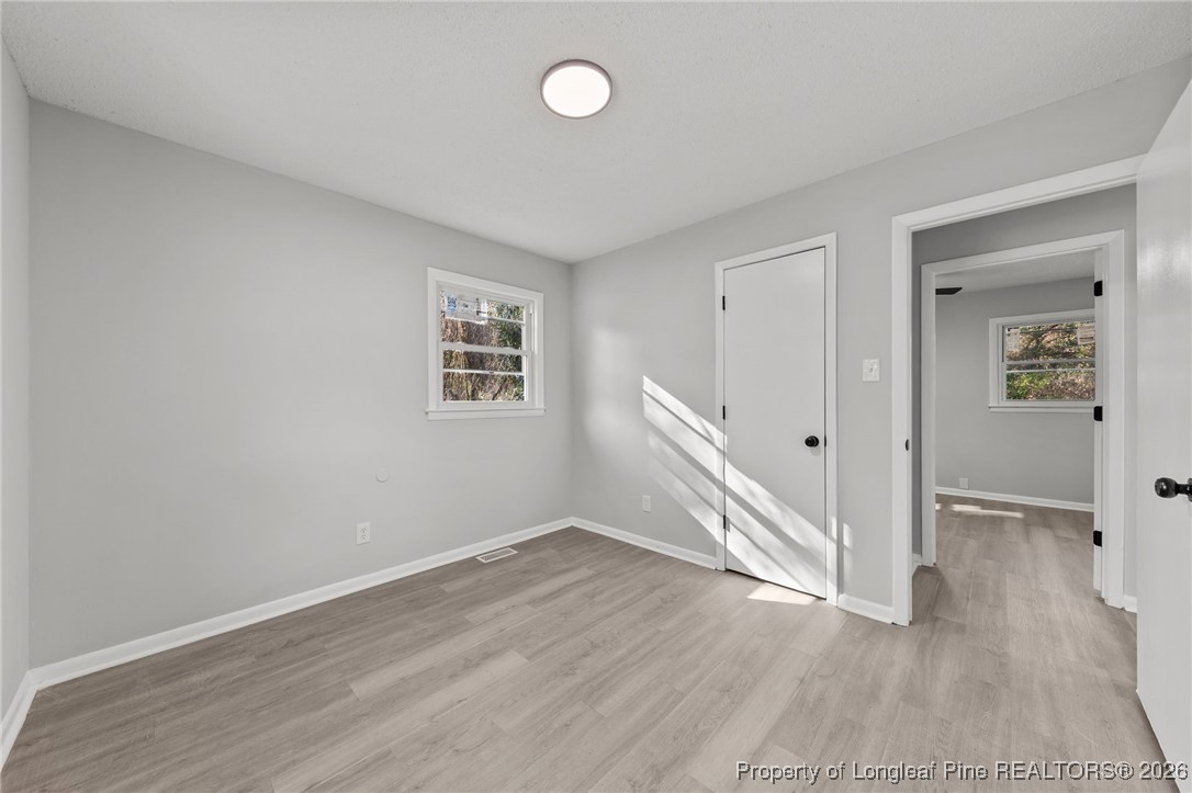 1509 Pope Street Raeford, NC 28376 - Photo 19 of 30 an empty room with wooden floor and windows