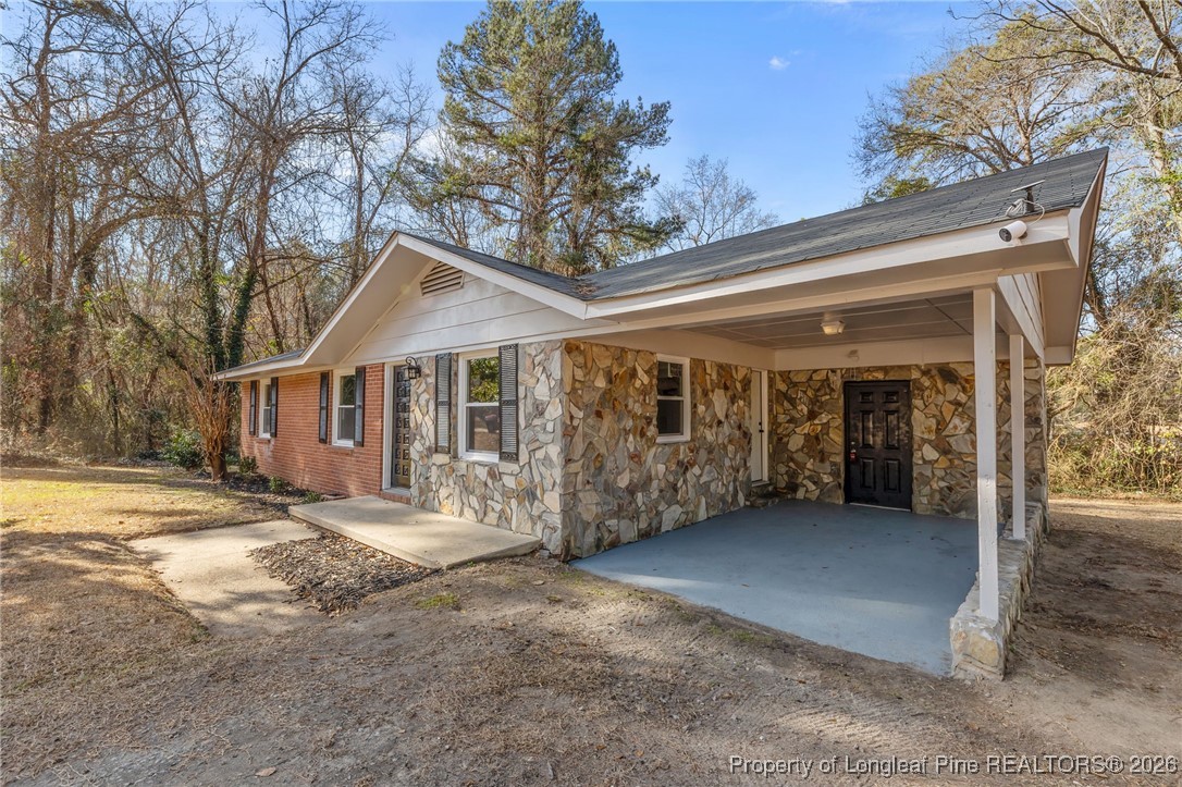 1509 Pope Street Raeford, NC 28376 - Photo 22 of 30 a view of a house with a large tree and wooden fence