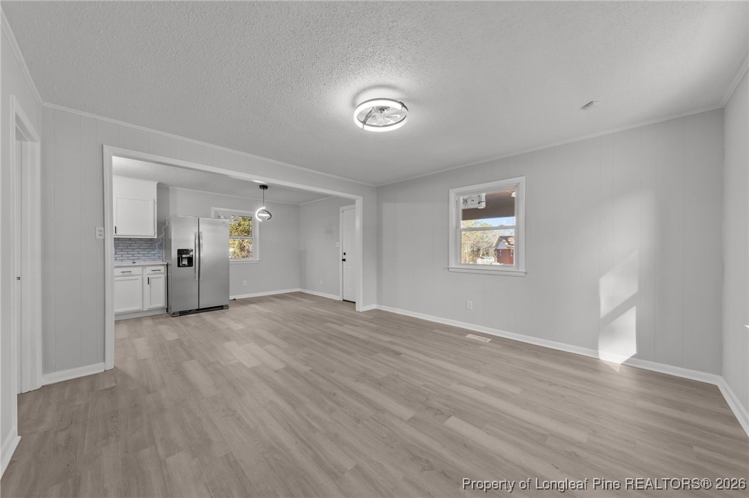 1509 Pope Street Raeford, NC 28376 - Photo 9 of 30 a view of an empty room with wooden floor and a window