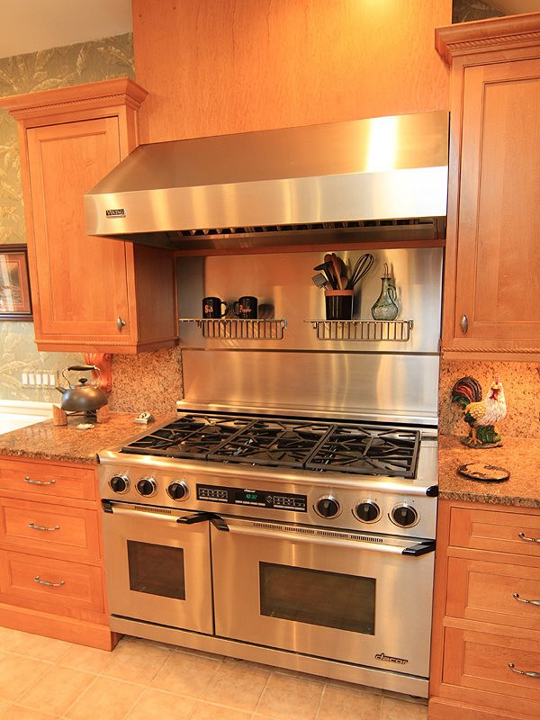 2204 Customs House Court Raleigh, NC 27615 - Photo 7 of 25 A closer photo of the cooking ability you can have. Stainless hood and backsplash behind the range, great lighting. Range