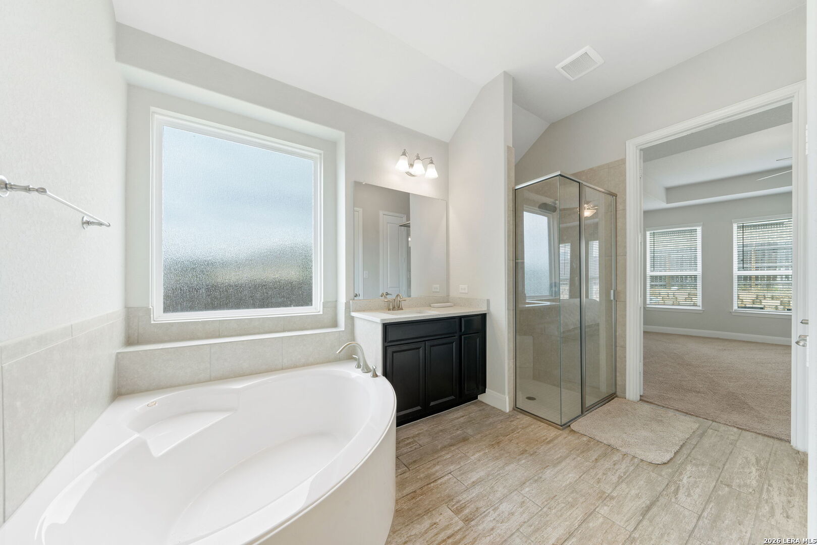 32103 Mirasol Bend Bulverde, TX 78163 - Photo 15 of 23 a bathroom with a bathtub shower and a sink