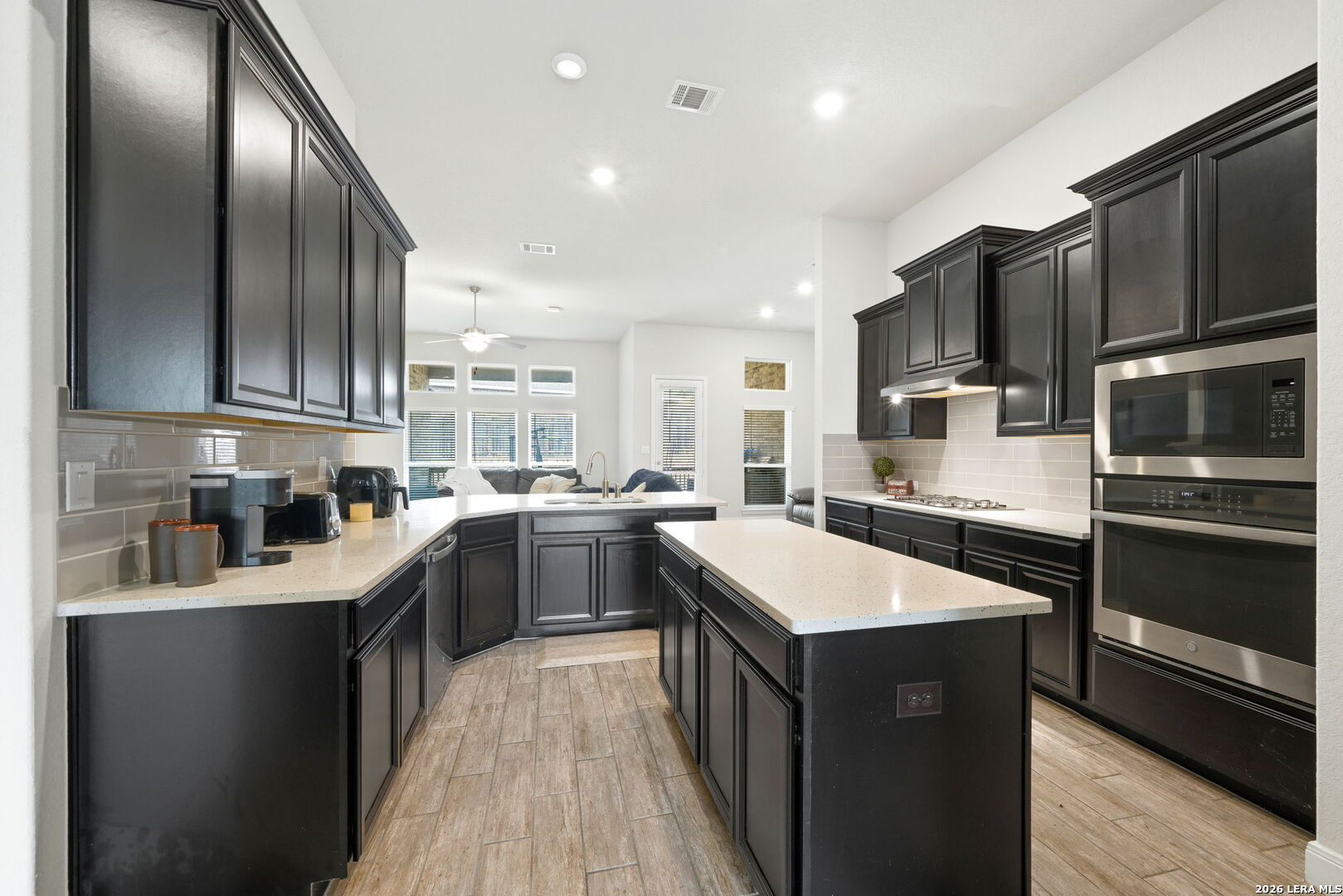 32103 Mirasol Bend Bulverde, TX 78163 - Photo 10 of 23 a kitchen with a sink stainless steel appliances and cabinets