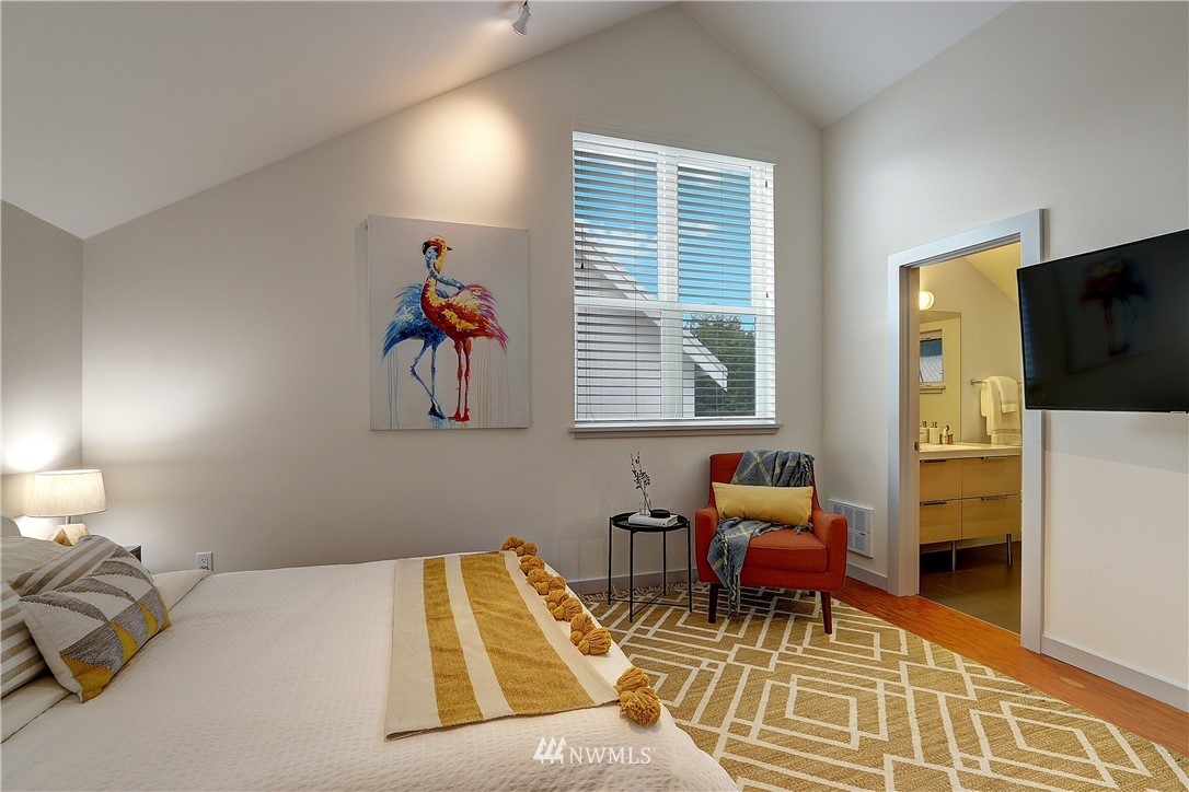 2771 59th Avenue Southwest Seattle, WA 98116 - Photo 11 of 23 a bedroom with a bed and wooden floor