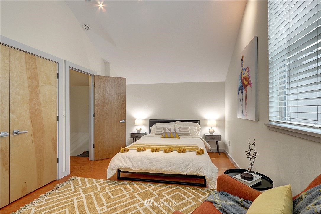 2771 59th Avenue Southwest Seattle, WA 98116 - Photo 12 of 23 a bedroom with a bed and a window