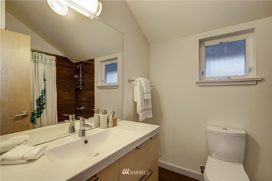 2771 59th Avenue Southwest Seattle, WA 98116 - Photo 13 of 23 a bathroom with a sink toilet and mirror