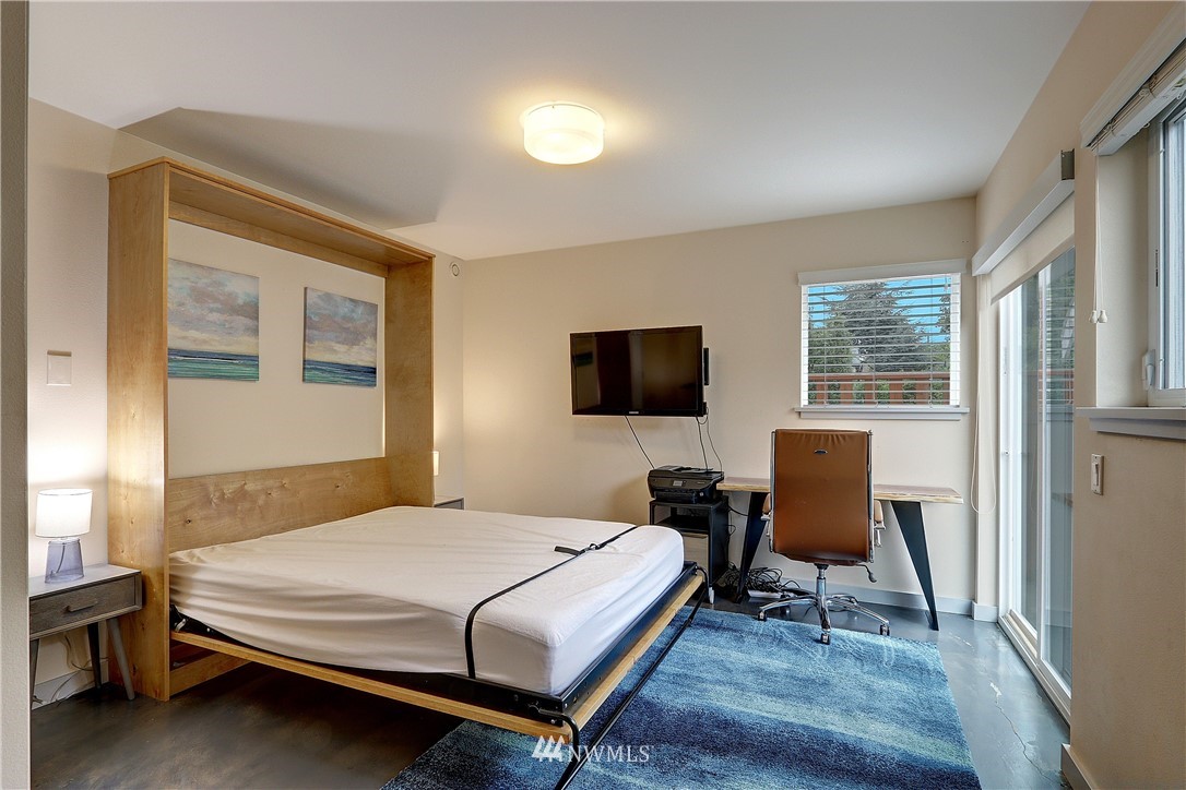 2771 59th Avenue Southwest Seattle, WA 98116 - Photo 15 of 23 a bedroom with a bed and a chair