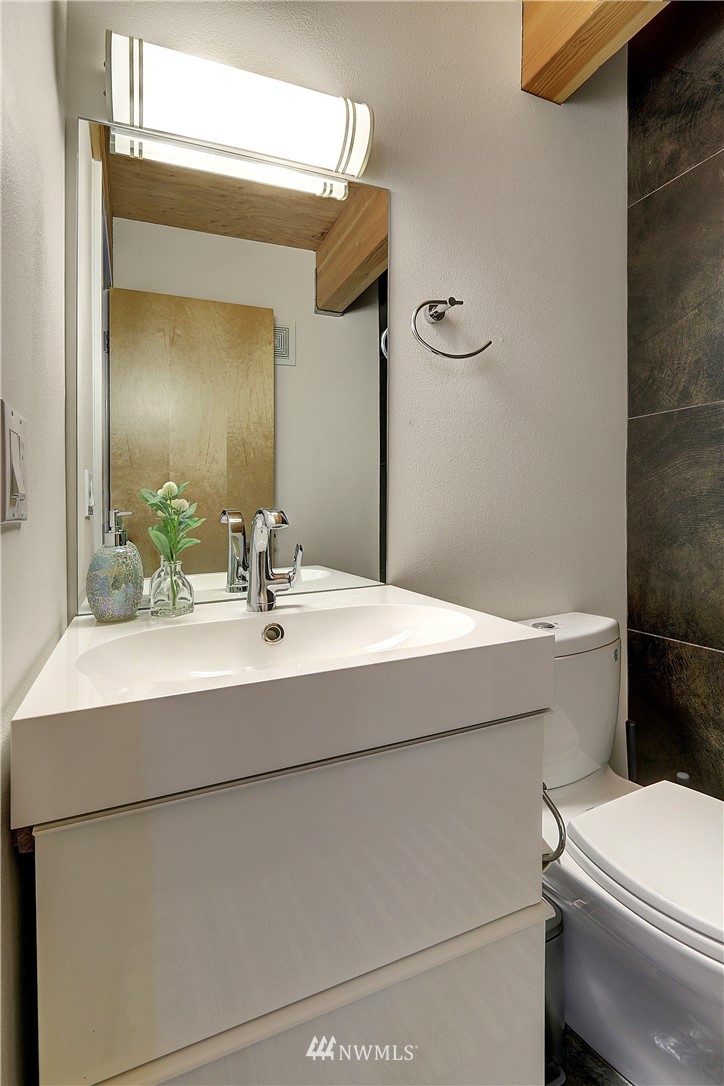 2771 59th Avenue Southwest Seattle, WA 98116 - Photo 8 of 23 a bathroom with a sink and a mirror