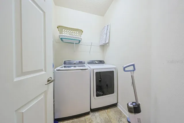 a view of a porch with chairs and floor to ceiling window