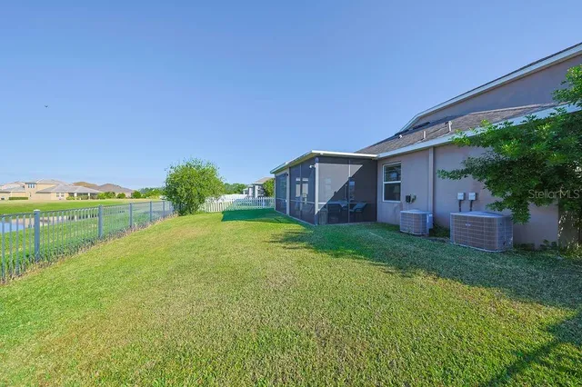 an aerial view of a house a lake and mountain view