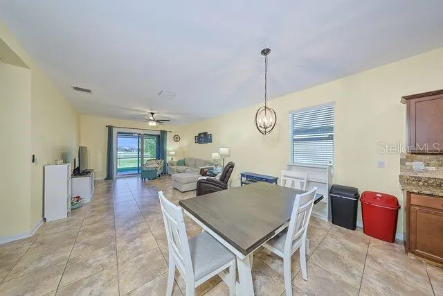 a view of a dining room and livingroom furniture wooden floor and a chandelier