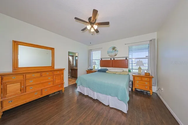 a bedroom with a bed and a dresser in it