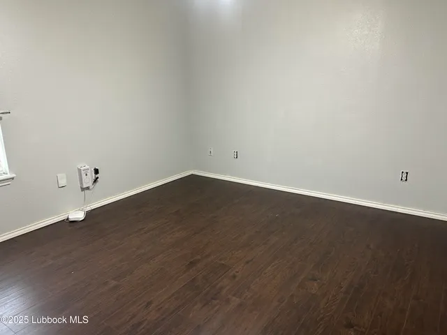 a view of a room with wooden floor
