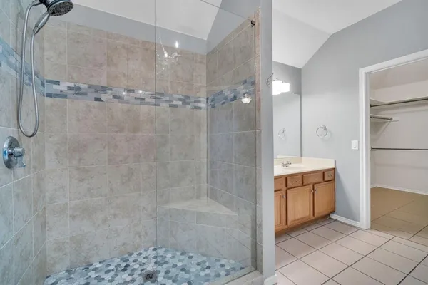 a spacious bathroom with a sink a toilet and a mirror