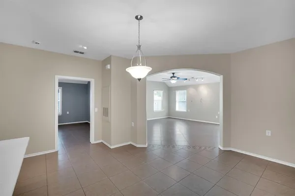 a view of a kitchen with a sink a microwave and cabinets
