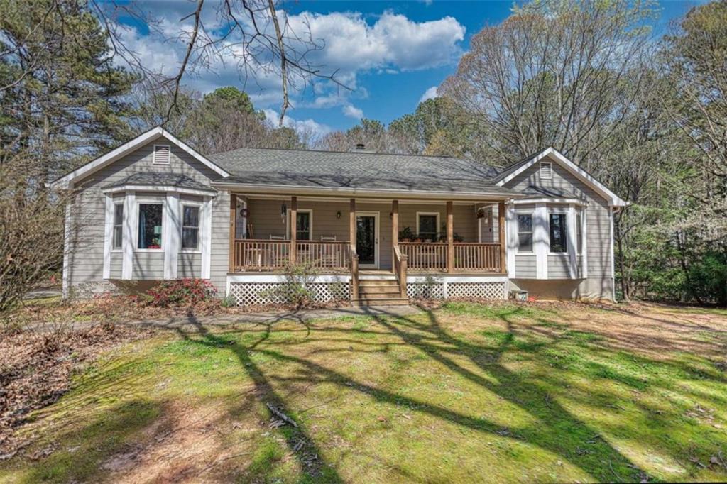2740 Dennard Road Northeast Conyers, GA 30013 - Photo 2 of 51 a front view of a house with a garden