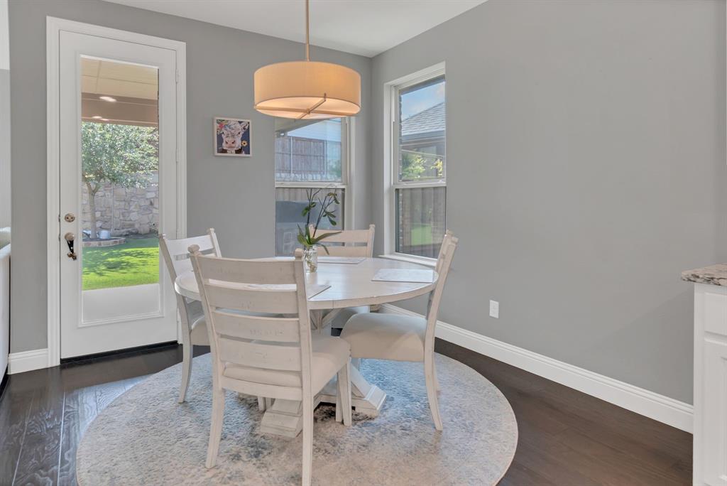 1920 Crescent Street Fort Worth, TX 76008 - Photo 11 of 40 a dining room with furniture a chandelier and wooden floor