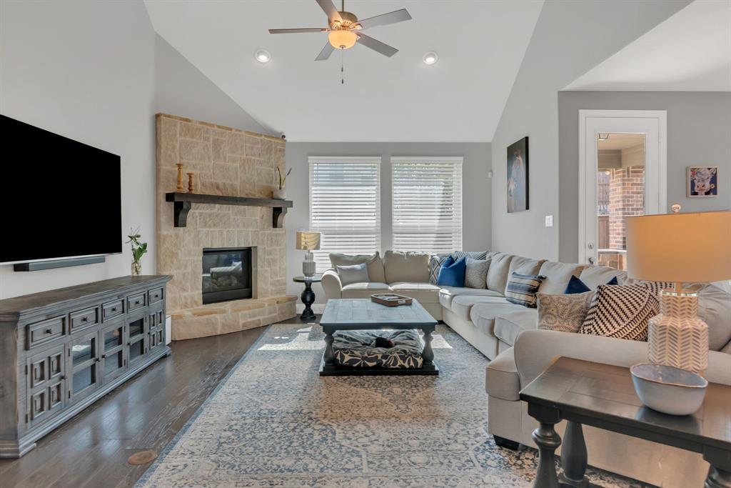1920 Crescent Street Fort Worth, TX 76008 - Photo 13 of 40 a living room with furniture a flat screen tv and a fireplace