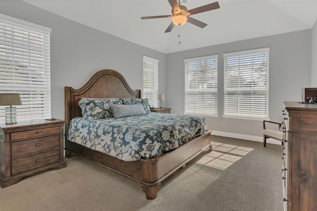 1920 Crescent Street Fort Worth, TX 76008 - Photo 15 of 40 a bedroom with a bed and a chandelier