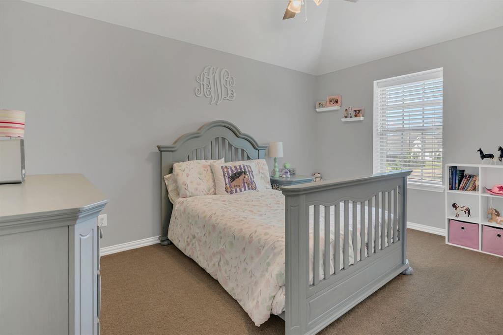 1920 Crescent Street Fort Worth, TX 76008 - Photo 30 of 40 a bedroom with a bed and a book shelf