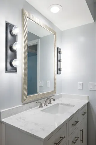 a bathroom with a sink and a mirror