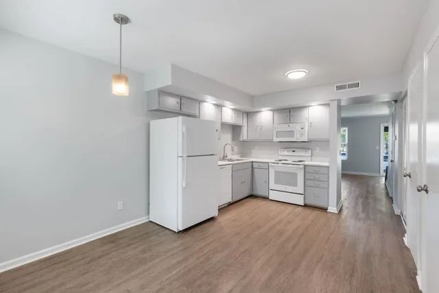 a kitchen with stainless steel appliances a refrigerator sink and cabinets