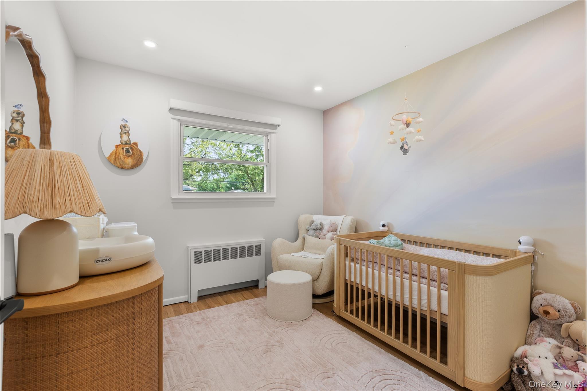 205 Timber Point Road East Islip, NY 11730 - Photo 6 of 16 Bedroom featuring radiator, a nursery area, wood finished floors, and recessed lighting
