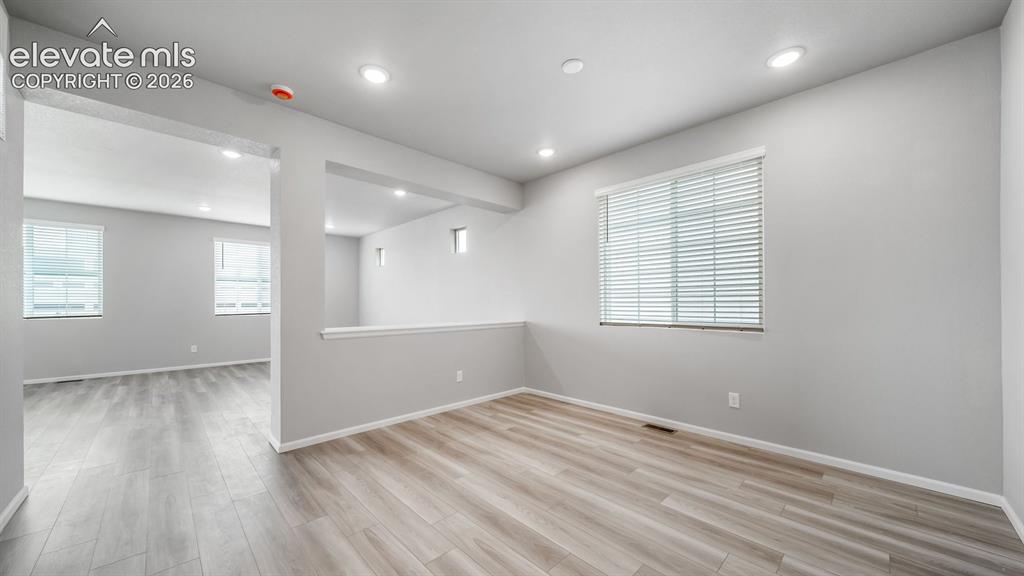 4896 Truscott Road Colorado Springs, CO 80925 - Photo 5 of 34 Light wood-finish flooring complements the neutral wall tonesPhotos of a Model Home