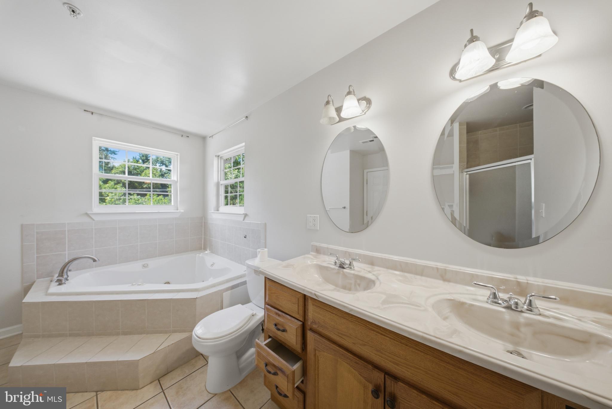 7611 Temple Hill Road Temple Hills, MD 20748 - Photo 14 of 25 a bathroom with a double vanity sink mirror and toilet