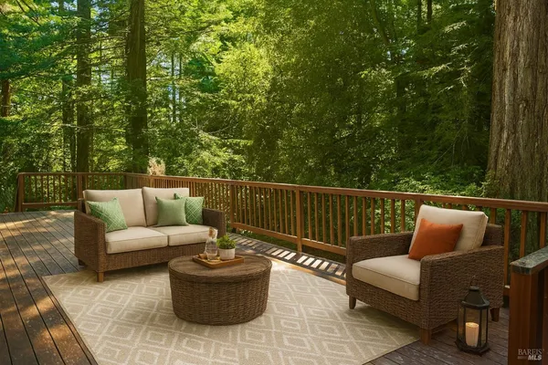 a roof deck with couches and wooden fence