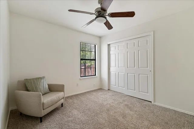 a living room with furniture and a ceiling fan