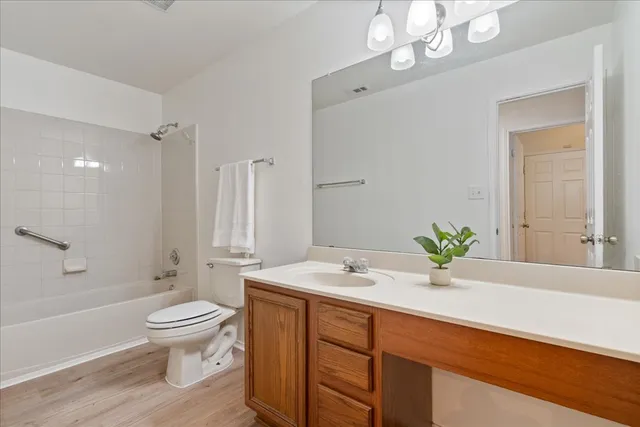 a bathroom with a sink a toilet and a large mirror