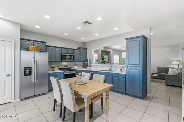 a kitchen with stainless steel appliances granite countertop a refrigerator and a stove top oven