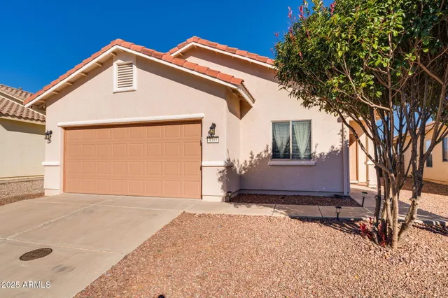 a kitchen with stainless steel appliances granite countertop a stove top oven a sink dishwasher a dining table and chairs