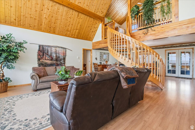 811 East Canyon Road Mayfield, UT 84643 - Photo 9 of 57 Spacious living area featuring a prominent wood spiral staircase, wood-finish flooring, vaulted wood plank ceiling with exposed beams, and double French doors