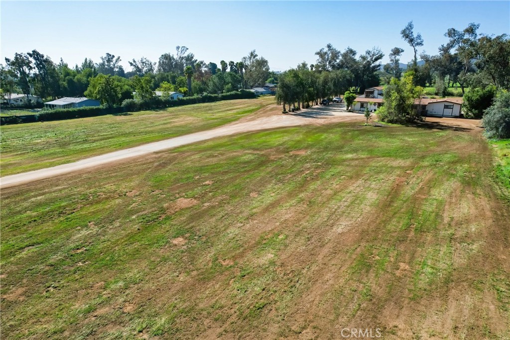 27355 Scott Road Menifee, CA 92584 - Photo 11 of 16 a view of yard with swimming pool and trees in the background