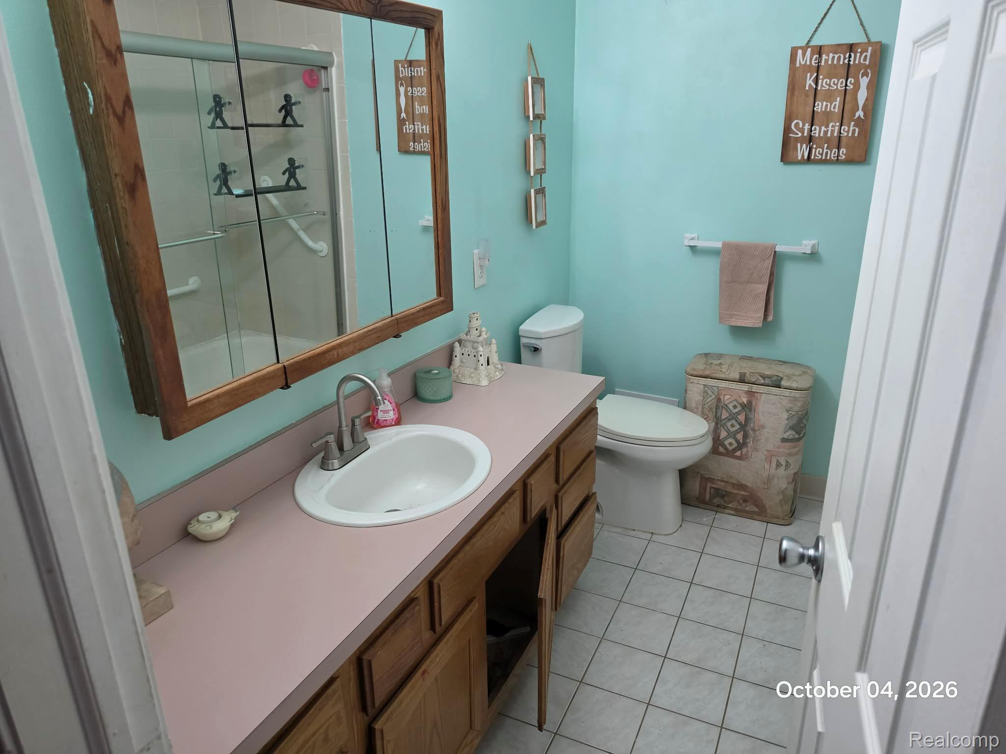 34781 Union Lake Road Clinton Township, MI 48035 - Photo 21 of 38 Bathroom featuring a single vanity with a white basin sink, wood-finish cabinetry, and a shower-tub combination