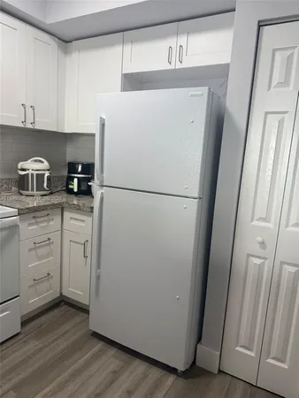 a white refrigerator freezer sitting in a kitchen