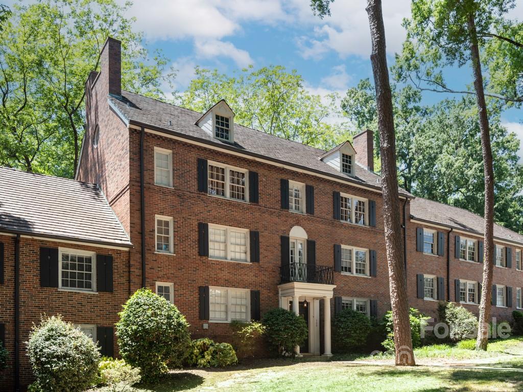 a front view of a building with a garden