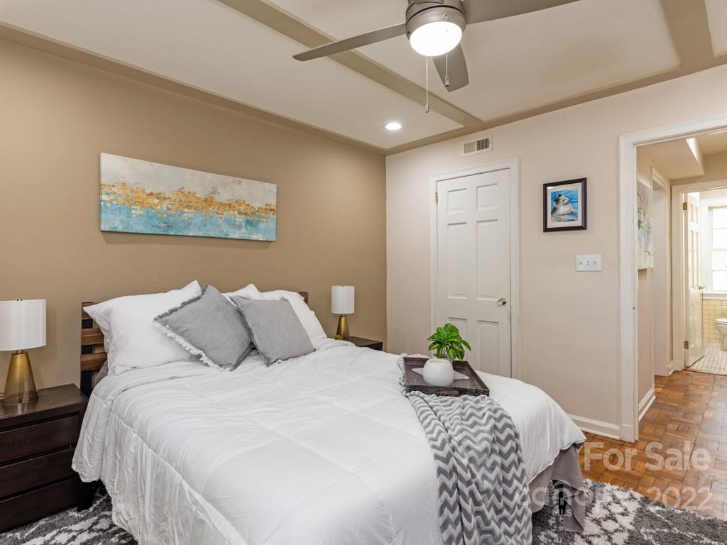 100 Colville Road, Unit 61A Charlotte, NC 28207 - Photo 12 of 15 a bedroom with a bed and a painting on the wall