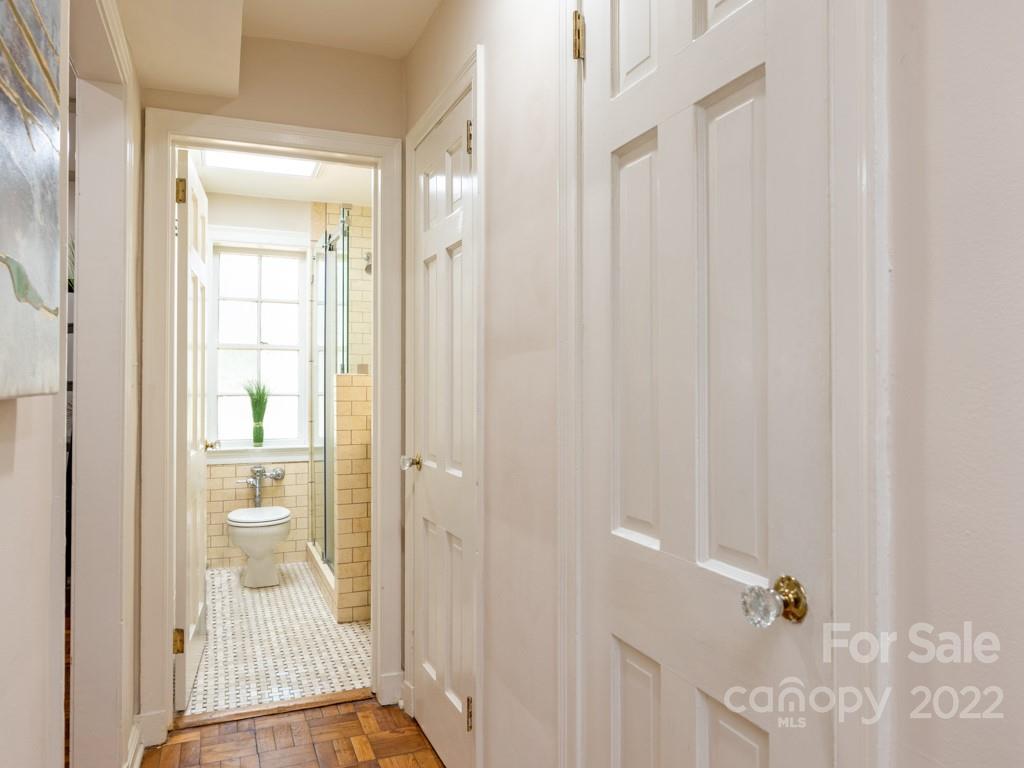 100 Colville Road, Unit 61A Charlotte, NC 28207 - Photo 13 of 15 a bathroom with a glass shower door