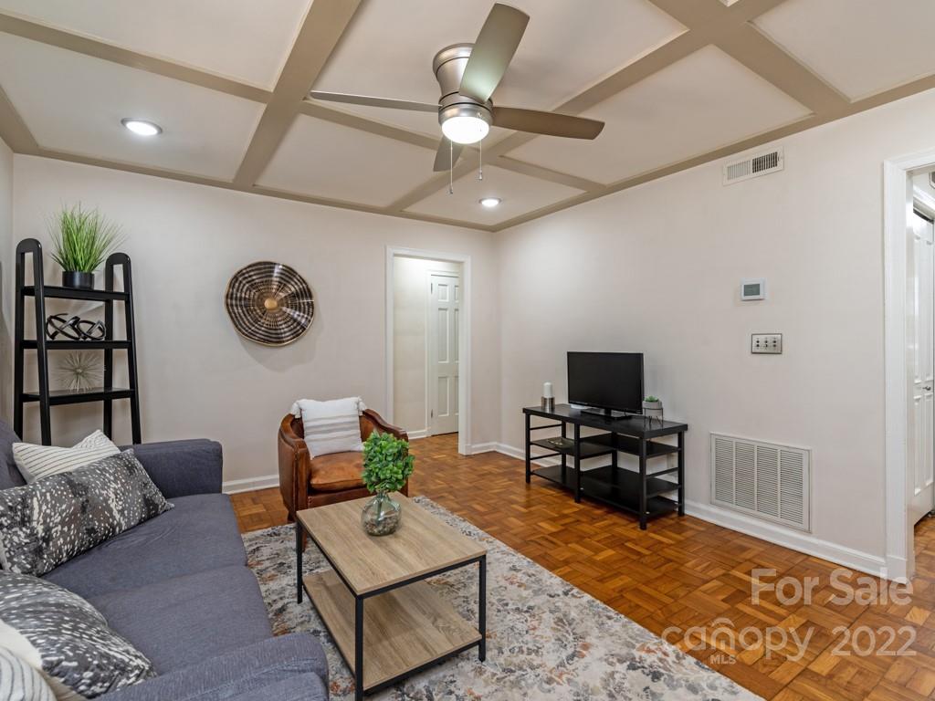 100 Colville Road, Unit 61A Charlotte, NC 28207 - Photo 3 of 15 a living room with furniture and a flat screen tv with kitchen view