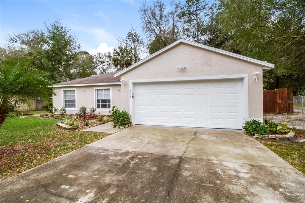 3331 Phonetia Drive Deltona, FL 32738 - Photo 1 of 1 a view of a house with yard and plants