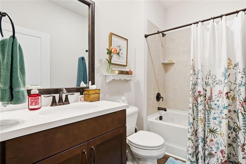 328 McQueen Way Canton, GA 30115 - Photo 11 of 66 a bathroom with a sink a toilet and a large mirror