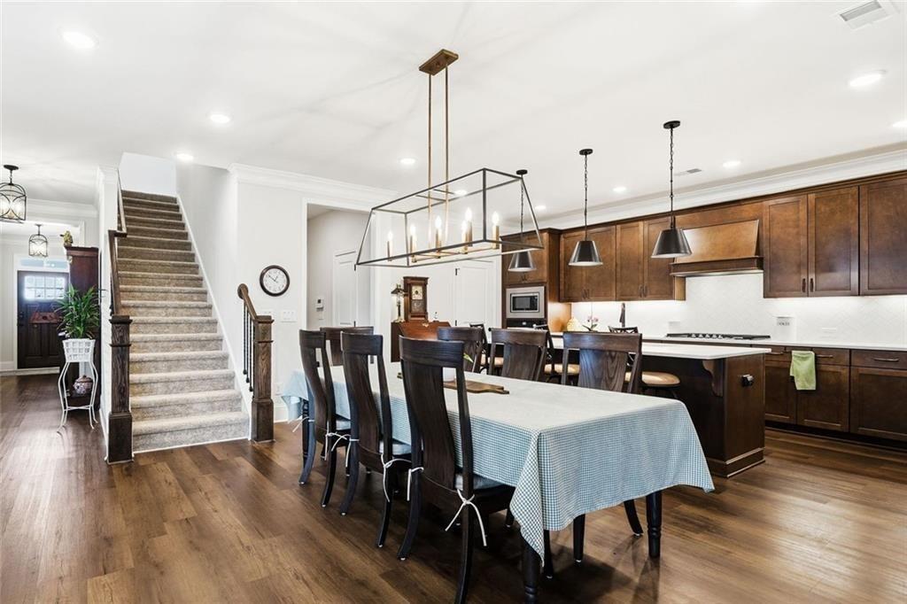 328 McQueen Way Canton, GA 30115 - Photo 19 of 66 a kitchen with stainless steel appliances granite countertop a kitchen island a stove a table and chairs