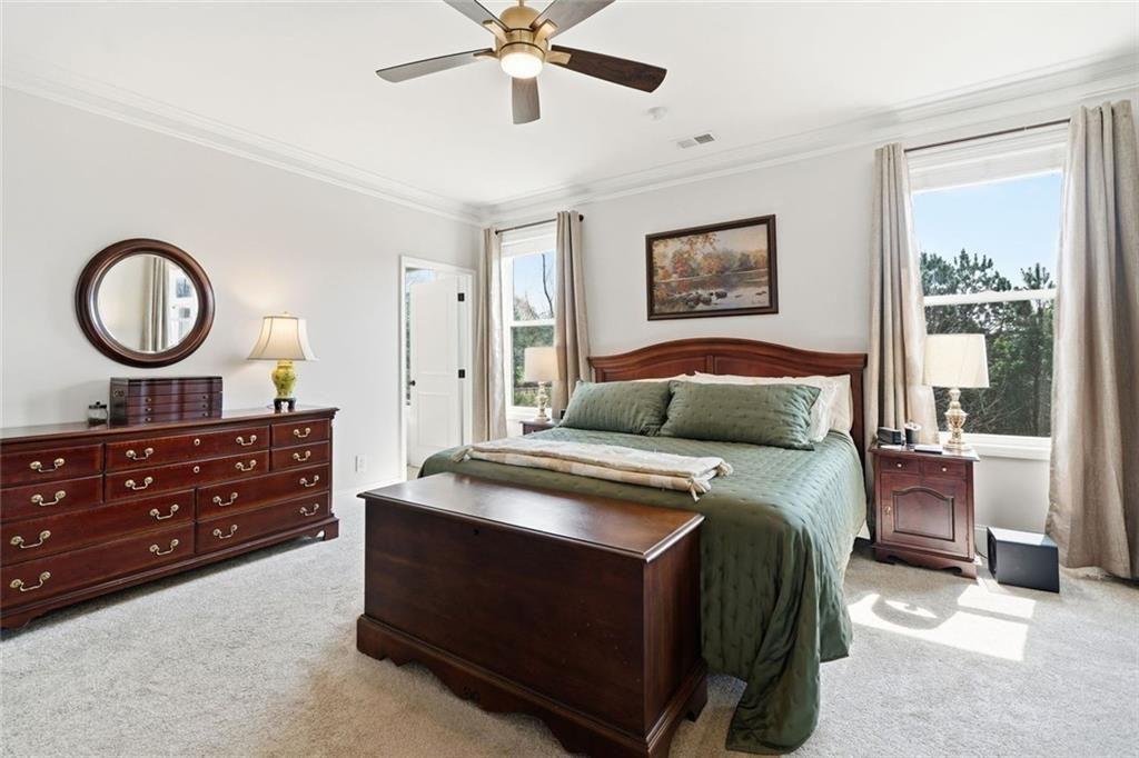 328 McQueen Way Canton, GA 30115 - Photo 26 of 66 a bedroom with a bed and a chandelier