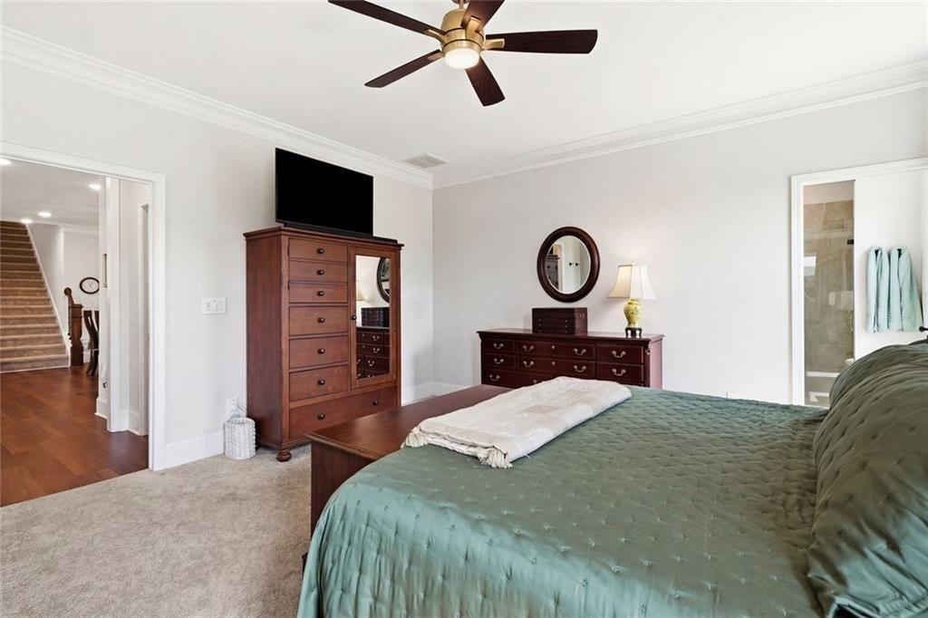 328 McQueen Way Canton, GA 30115 - Photo 27 of 66 a bedroom with a bed and a flat tv screen on dresser