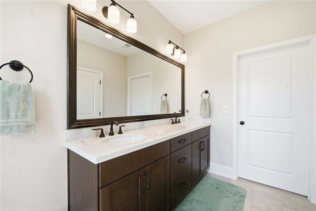 328 McQueen Way Canton, GA 30115 - Photo 29 of 66 a bathroom with a double vanity sink and mirror